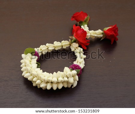Garland of jasmine flower on wood background