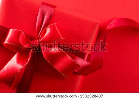 Top view of red christmas boxes with red ribbon on black background with copy space for text. black Friday and Boxing Day composition.