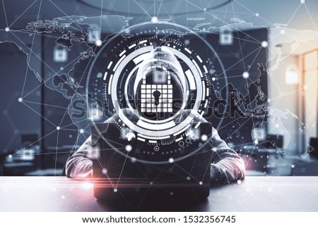 Hacking and protection concept. Hacker at desktop using laptop with glowing padlock map hologram on blurry office interior background. Double exposure  