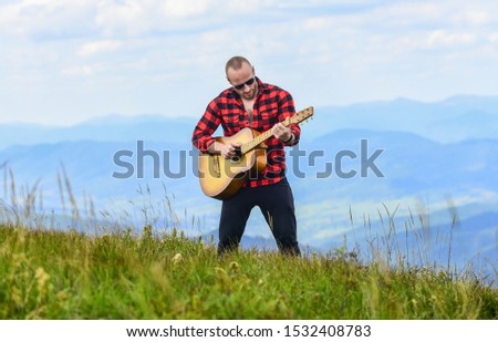 Acoustic music. Keep calm and play guitar. Man hiker with guitar on top of mountain. Hiker enjoy nature. Musician hiker find inspiration in mountains. Music for soul. Playing music. Sound of freedom.