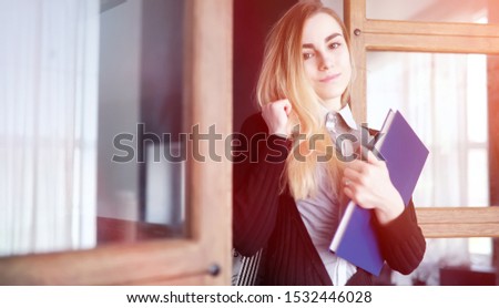 Young pretty blonde girl student before class
