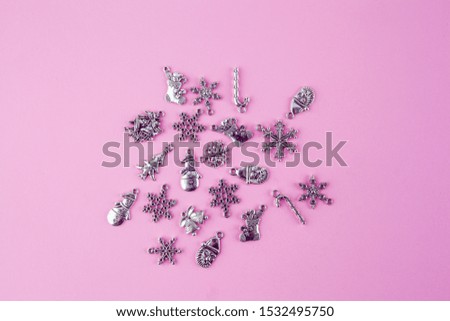 Silver Christmas decorations on pink background - top view with copy space