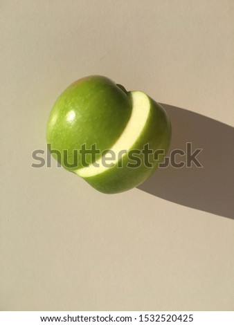 Sliced green fresh apple isolated on white. Wallpaper picture.
