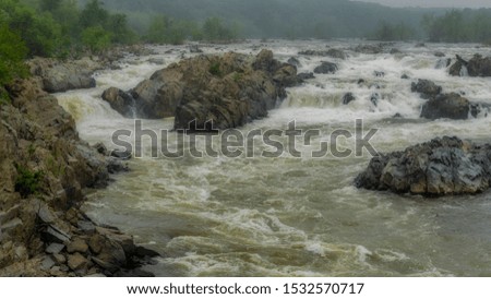 Rushing water at Great Falls National Park on a stormy overcast day