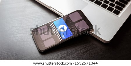 Cross Targeting Programmatic Advertising audience ads concept illustration. Online native inbound advertising concept with smartphone and laptop on dark wood table Royalty-Free Stock Photo #1532571344
