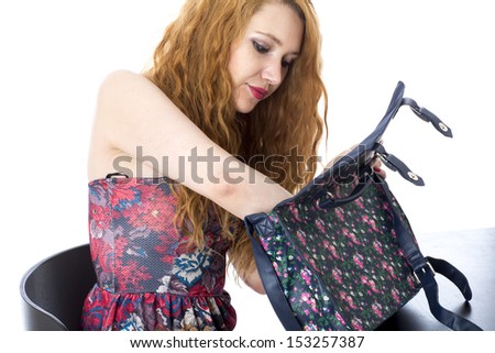 Beautiful Young Woman, In Her Thirties, With Red Hair Looking Through Handbag, Isolated On White