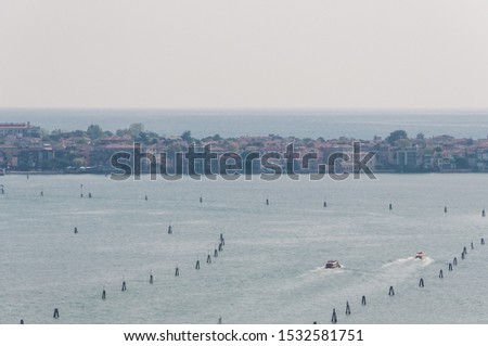 Aerial view of Venice lagoon and Lido island with historic buildings and sea resorts. Popular vacation spot scene