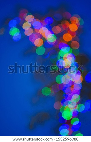 Blurred and defocused abstract multicolor background with christmas lights, soft multicolored bokeh circles.