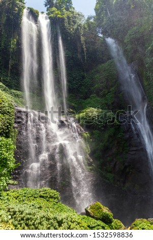 Sekumpul Waterfalls in Bali, Indonesia.Waterfall in green forest. Triple tropical waterfall Sekumpul in mountain jungle.