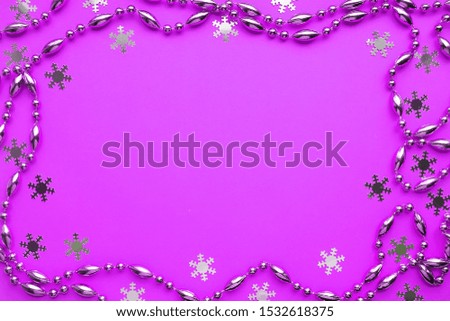 Christmas frame of garland on pink background 
