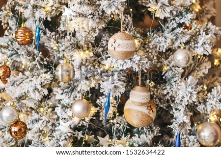 Christmas and New Year background. Winter interior decor with artificial spruce branches, garlands and colorful balls. Desing element. Shallow depth of field. Copy space.