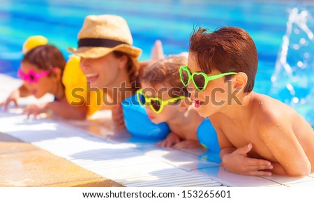 Happy family in the pool, having fun in the water, mother with three kids enjoying aquapark, beach resort, summer holidays, pleasure concept  Royalty-Free Stock Photo #153265601
