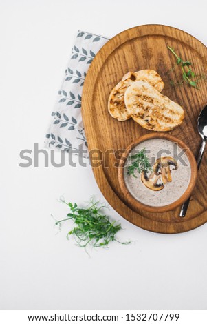 Delicious mushroom soup on wooden board– stock image