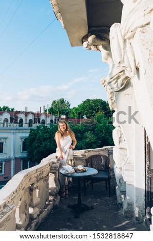 Beautiful young girl on the balcony