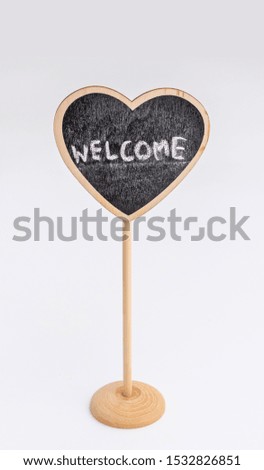 WELCOME text on small heart symbol wood label