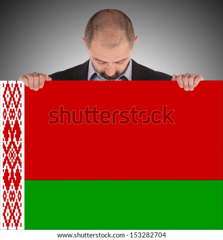 Businessman holding a big card, flag of Belarus, isolated on white
