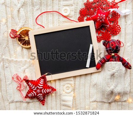 Flat lay view of empty black chalkboard for making Christmas gifts wish list, card or write a letter to Santa Clause, Christmas commercial background.
