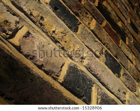 Looking up at dark brown brick wall