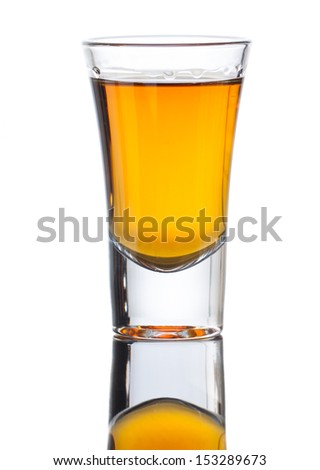 A small shot glass of delicious single malt whiskey with reflection . Isolated on white Royalty-Free Stock Photo #153289673