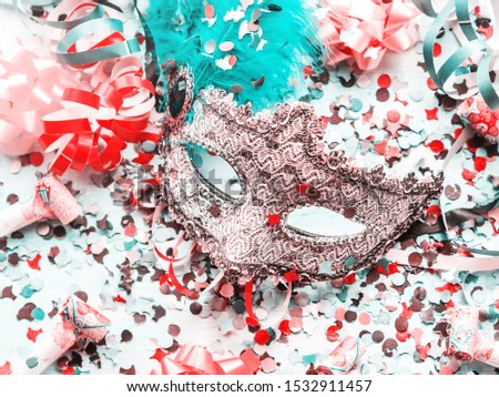 Colorful cranival Mardi gras background with masquerade carnival mask and confetti, streamers, bows. Party items.