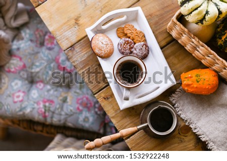 Autumn and winter home still life. View from above. The concept of home atmosphere and decor. Wooden table biscuit cookies with cinnamon. Pumpkins of different colors