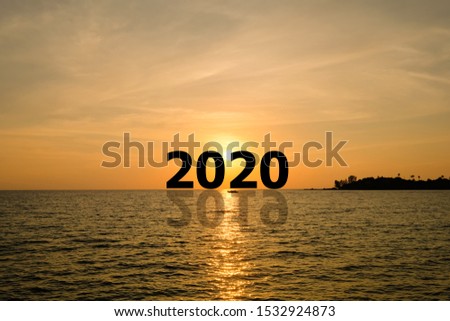 Happy new year 2020 concept with golden sky and white clouds over the island in sunset