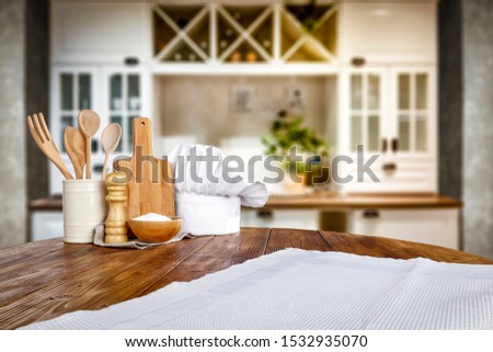 Table background of free space for your decoration and blurred furniture of kitchen. Chritmas time in home. 