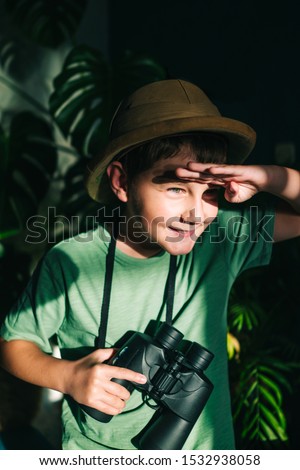 Little boy with binoculars and safari hat Royalty-Free Stock Photo #1532938058
