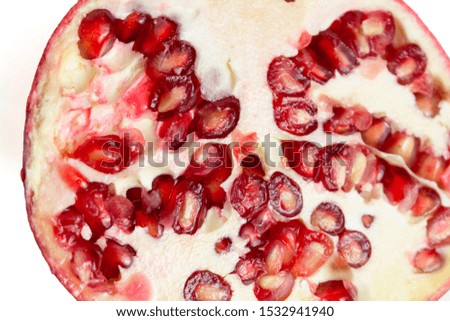 Red pomegranate half cutaway on a white background isolate