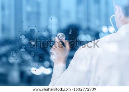The concept of medical care 24 hours a day. The doctor listens medicine icons to on blurred background.