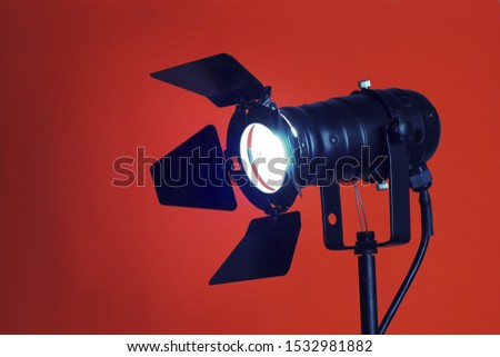 A studio spotlight facing the camera on a bright background