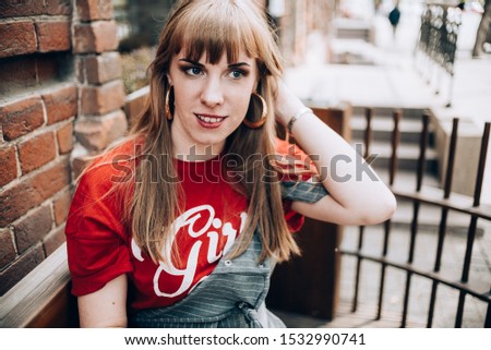 Beautiful girl in a red t-shirt in the park