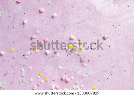 Colorful party flat lay, happy birthday, tasty colorful sweet candy treats on pink background, top view