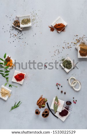 Herbs and spices on ceramic tile background