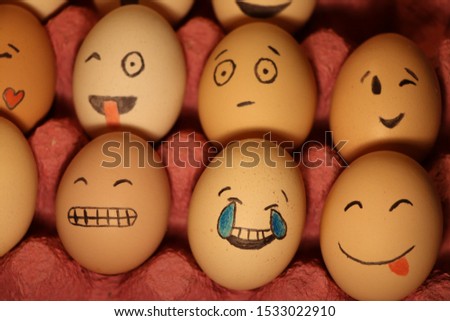 Drawing funny and cute face emoji on egg