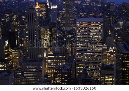 New york city lights of business offices in Manhattan at dusk or dawn. Urban cityscape at twilight. Concept of overpopulated megapolis. USA/America. Home office concept during coronavirus.  