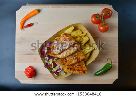Fast food isolated on black on a wooden board
