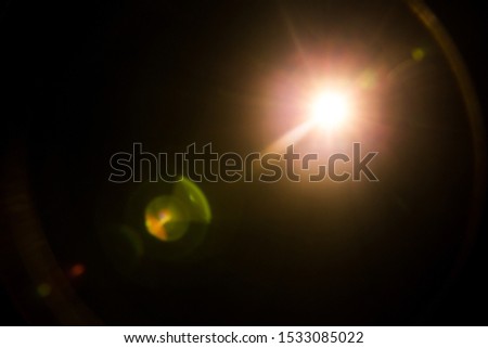 abstract lens flare red light over black