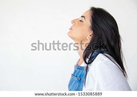 Side view of beautiful young woman on white. Relaxed attractive brunette with closed eyes. Concept of relaxation