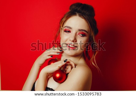 beautiful young and fashion girl with red christmas toy
