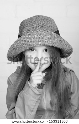 cute cheerful young girl with long hair in a stylish hat