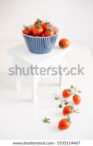 Cherry tomatoes.Cherry tomatoes in ceramic bowl on wooden whıte background