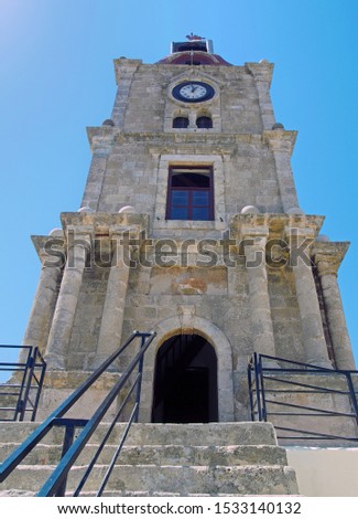 the historic roloi medieval clock tower in rhodes town against a blue sky