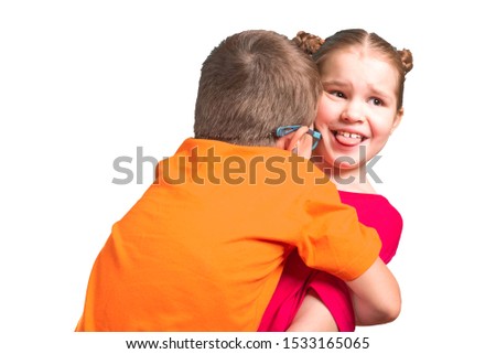 Brother and sister hugging and smiling. Isolated on a white background.
