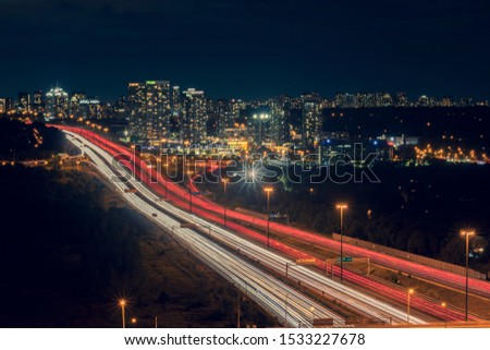Beautiful City lights, Cityscape, Night Long Exposure from DVP Car fast, Speed Traffic on 401 Highway Toronto Canada with Cityscape on Yonge Street Royalty-Free Stock Photo #1533227678