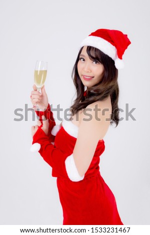 Beautiful portrait young asian woman in Santa holding glass of champagne with party celebrating in xmas holiday isolated on white background, asia girl drink beverage, Christmas and new year concept.