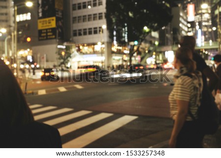 People walking at footpath in  night time with light bokeh
Crowded street in Japan, blurred background in japan 
for background usage.