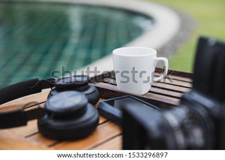 cup of coffee with music player, headphones and Medium format camera in holiday