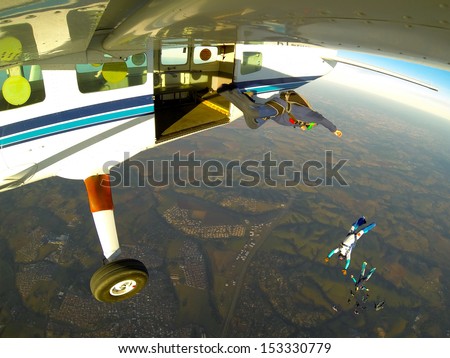Skydiving people exit, point of view from airplane.