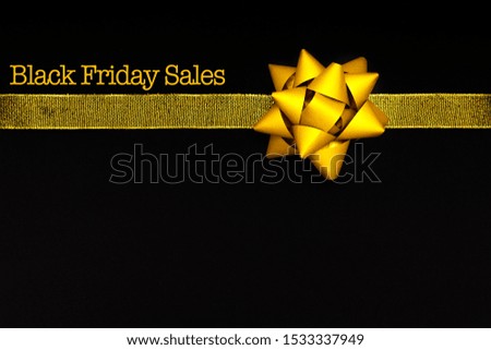 Black Friday sale, golden bow on black background
